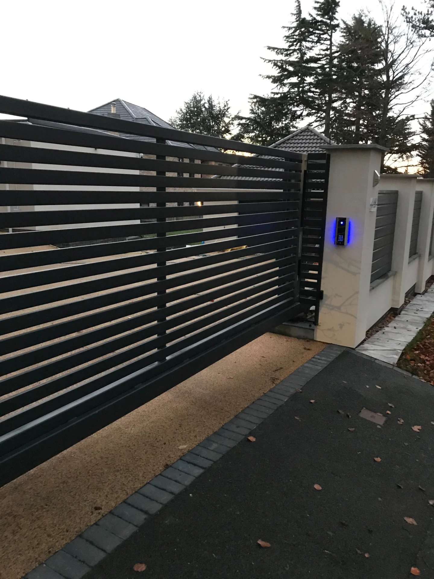 a black fence with a blue light on it